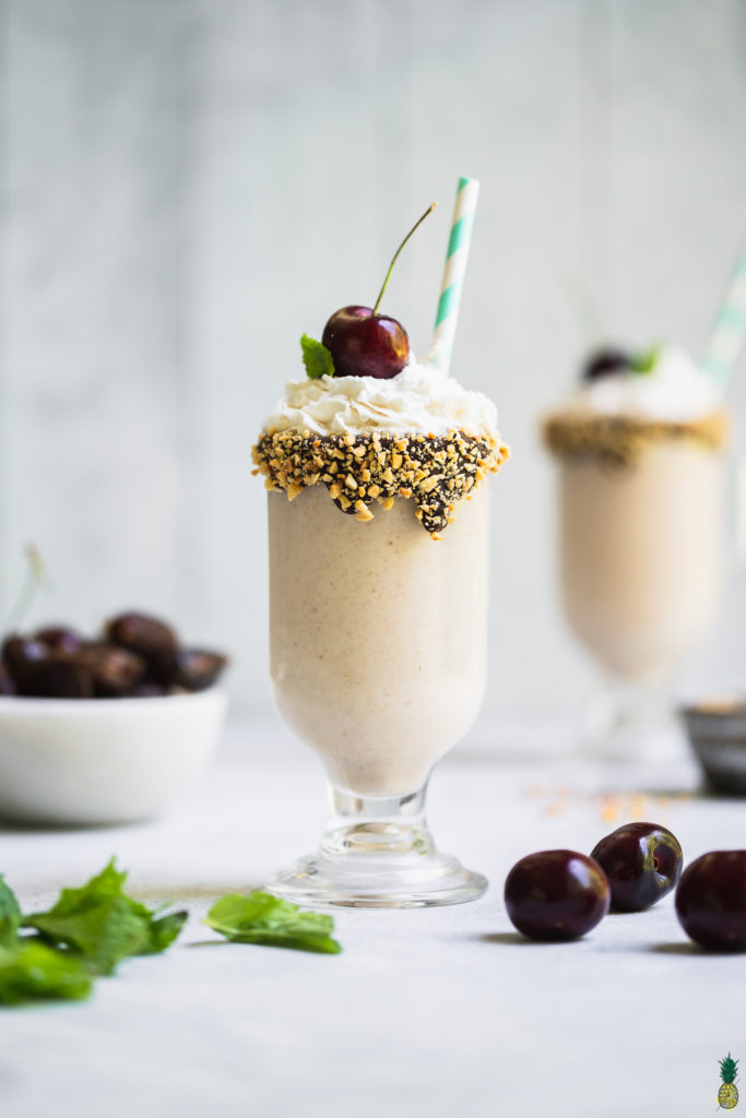 date ice cream shake with whipped cream and cherry by sweet simple vegan