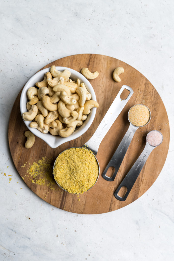 Learn how to make your own vegan parmesan cheese at home. It requires just 4 ingredients and only about 5 minutes of your time! Trust us, this recipe is a MUST TRY! #vegan #cheese #4ingredient #5minute #staple #vegancheese #kids #musttry #side #snack #entree #italian #parmesan #sweetsimplevegan