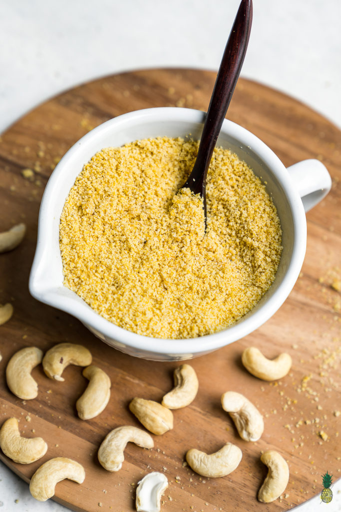 Learn how to make your own vegan parmesan cheese at home. It requires just 3 ingredients and only about 5 minutes of your time! Trust us, this recipe is a MUST TRY! #vegan #cheese #3ingredient #5minute #staple #vegancheese #kids #musttry #side #snack #entree #italian #parmesan #sweetsimplevegan