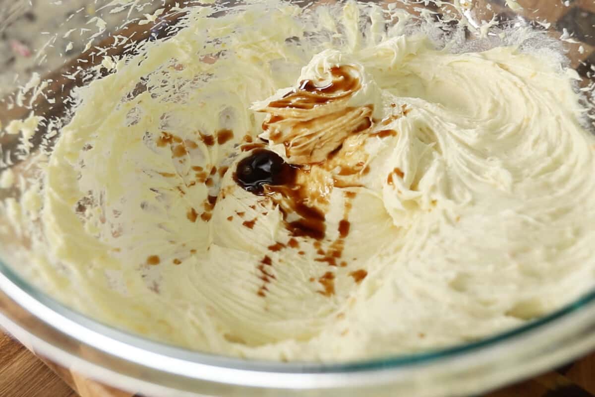 step by step - vanilla being added to bowl of creamed butter and sugar