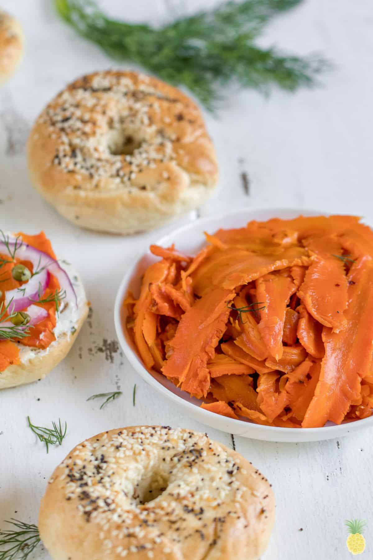 Bowl of carrot lox with bagels.