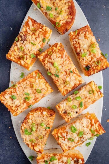 overhead of gochujang garlic bread sprinkled with green onions