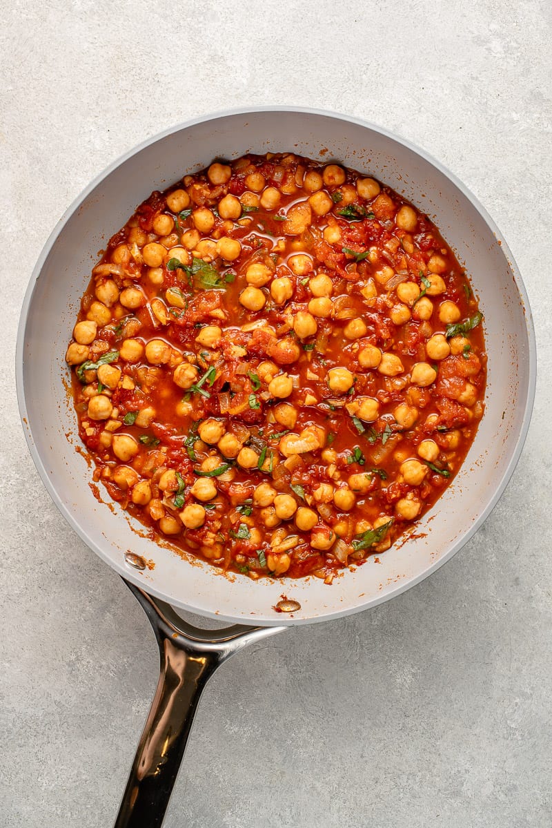 spiced chickpeas and tomatoes in gray pan