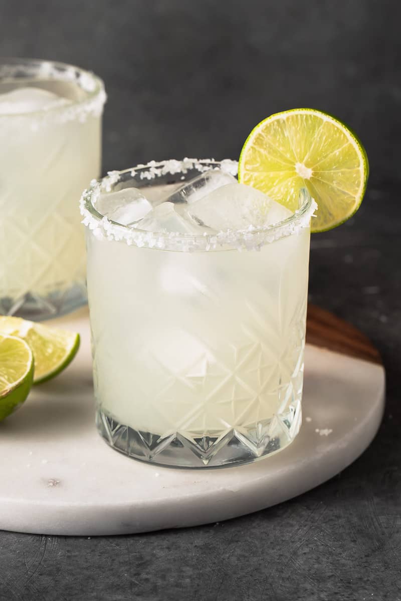 straight forward image of classic margarita in a glass with a lime garnish