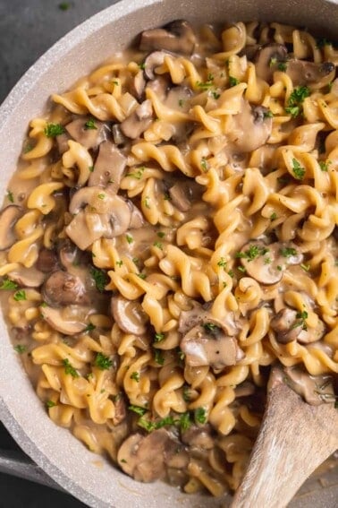 overhead close up image of mushroom stroganoff with wooden spoon
