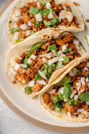 close up photo of tofu taco meat in tortilla