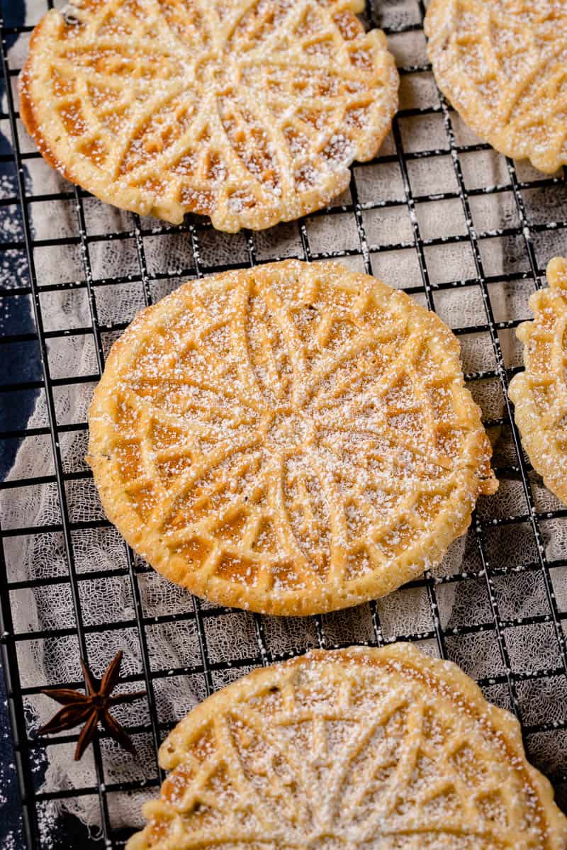 finished pizzelles dusted with powdered sugar