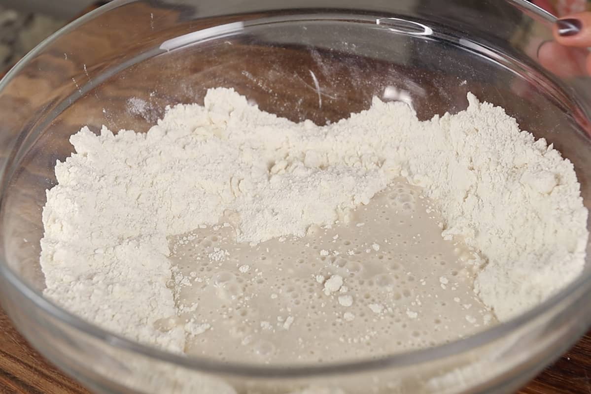 making dried cherry scones dough in a glass bowl