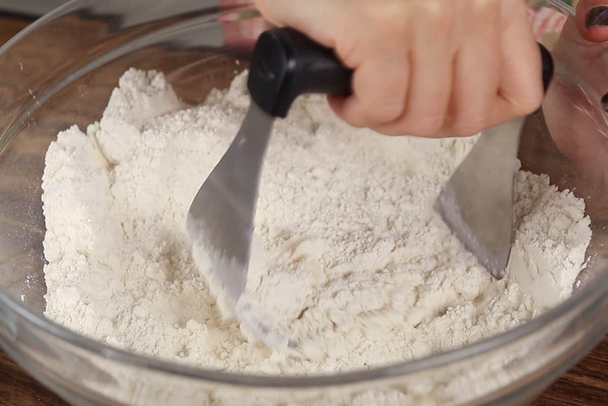 making dried cherry scones dough in a glass bowl