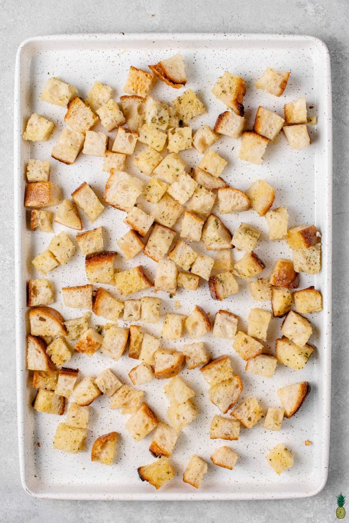 overhead image of diced bread on sheet pan