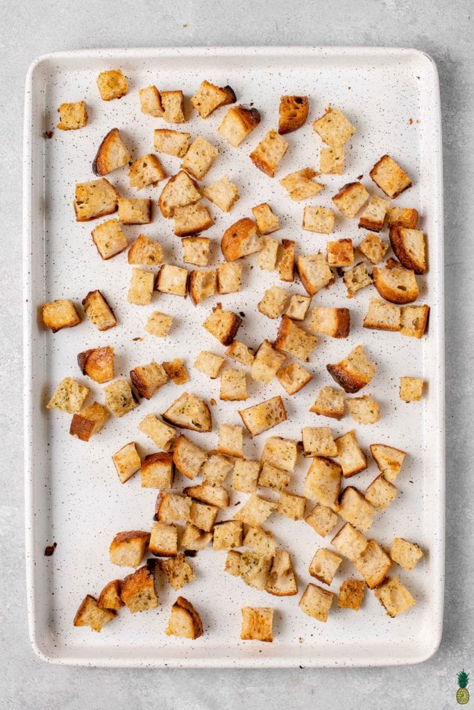 overhead image of baked croutons on a sheet pan