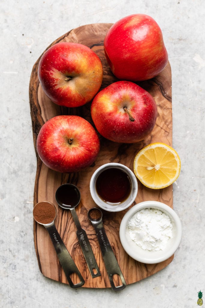 Ingredients for vegan apple crisp on a wooden board by sweet simple vegan