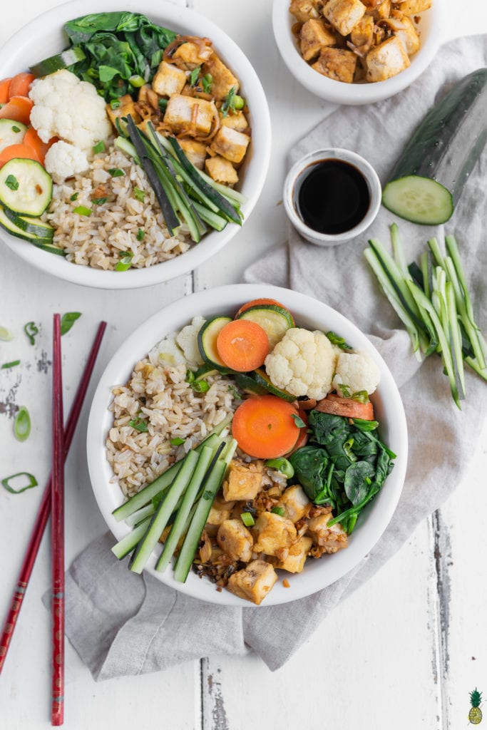 Lemongrass tofu in buddha bowls with steamed vegetables and fried rice