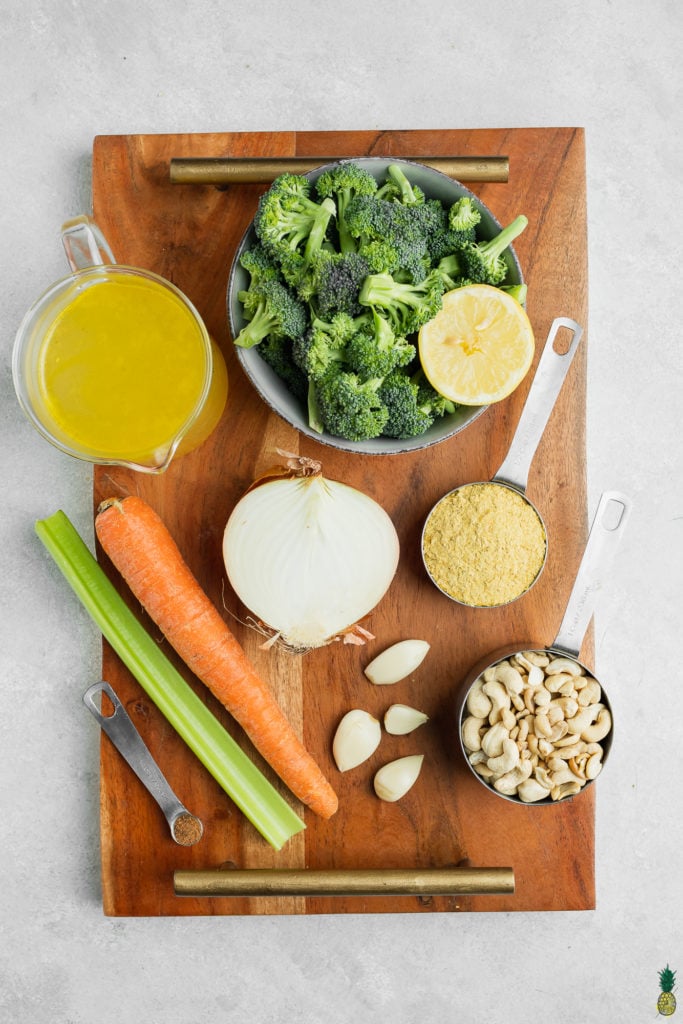 Ingredients for vegan broccoli cheddar soup on a wooden board
