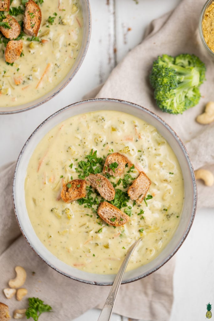 Vegan Broccoli Cheddar Soup in a bowl with croutons and parsley