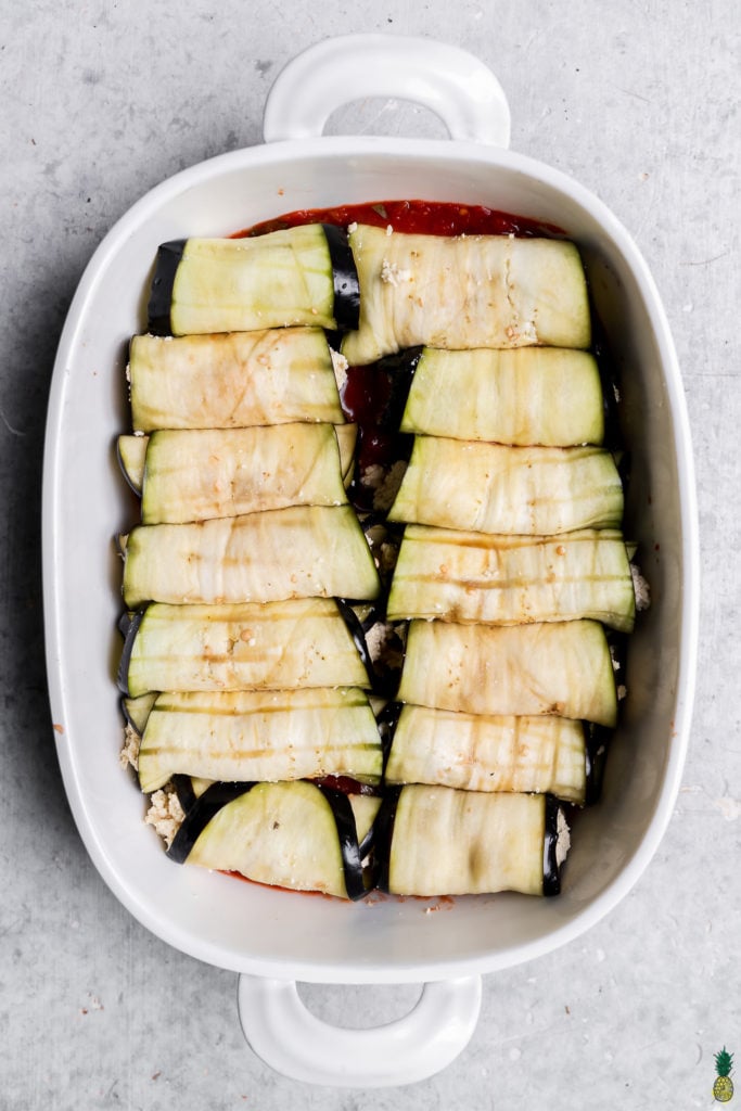 Step by step overhead image of eggplant rollatini in a baking dish with no cheese or sauce