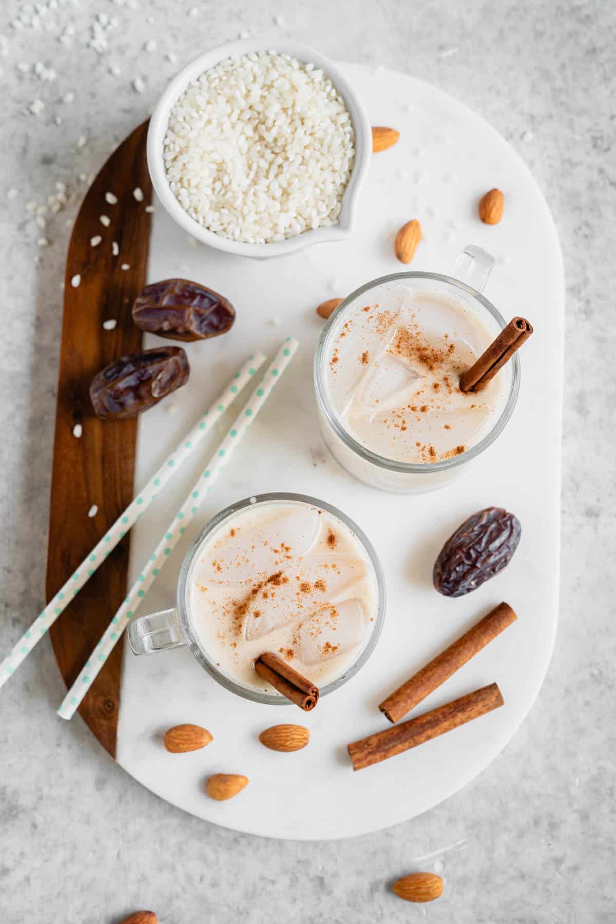 overhead photo glass cups with date sweetened horchata and cinnamon sticks