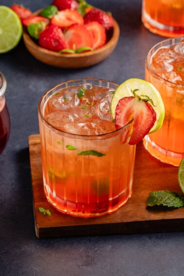 Strawberry Mojito Mocktails on a wooden board and blue table