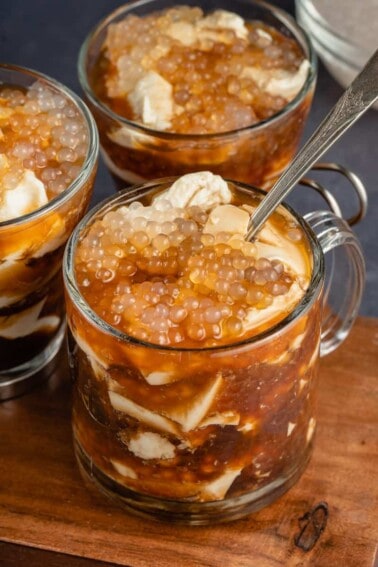three glasses of taho on wooden board with 1 spoon