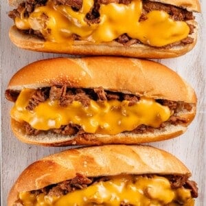 3 vegan soy curl Philly cheesesteaks on white board
