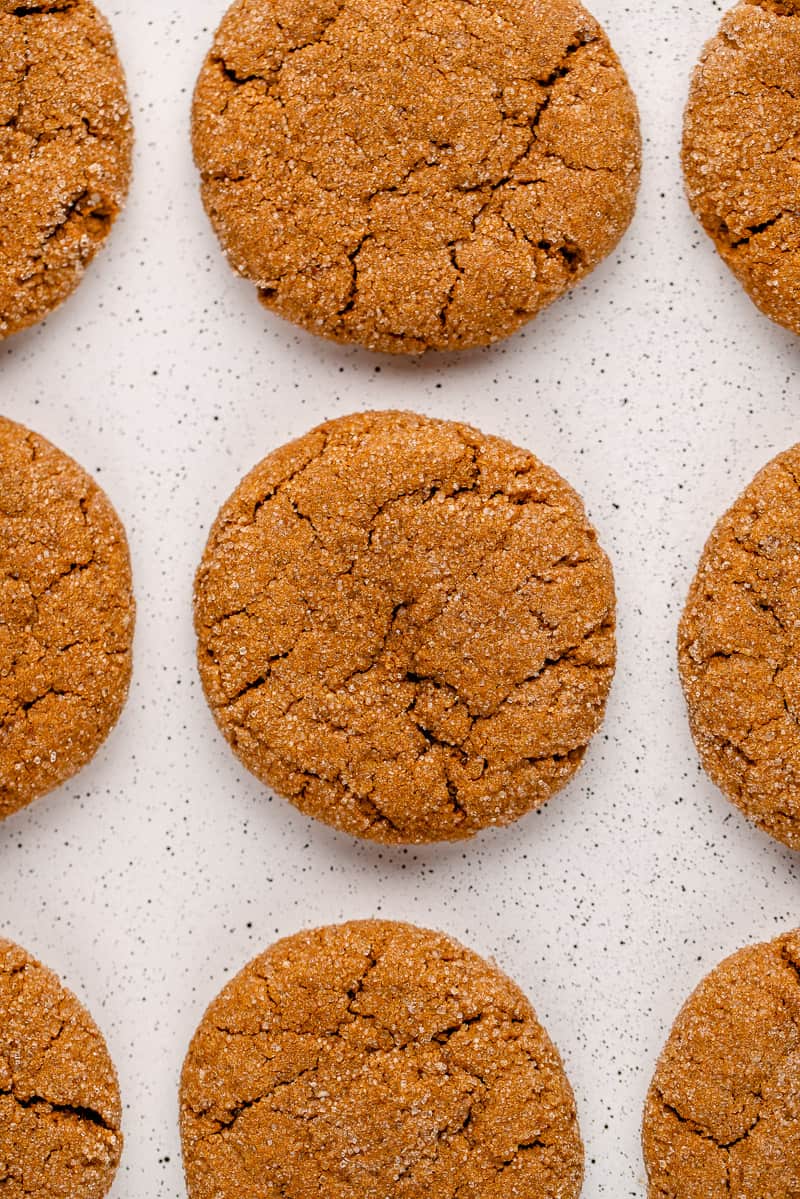 overhead shot of vegan ginger molasses cookies on a white speckled tray