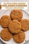 overhead shot of vegan ginger molasses cookies on a white speckled plate with a blue towel for pinterest