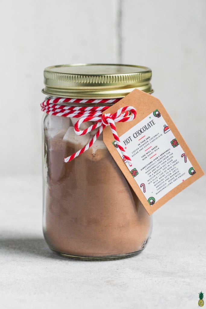 vegan hot cocoa mix in a jar with marshmallows and a tag by sweet simple vegan