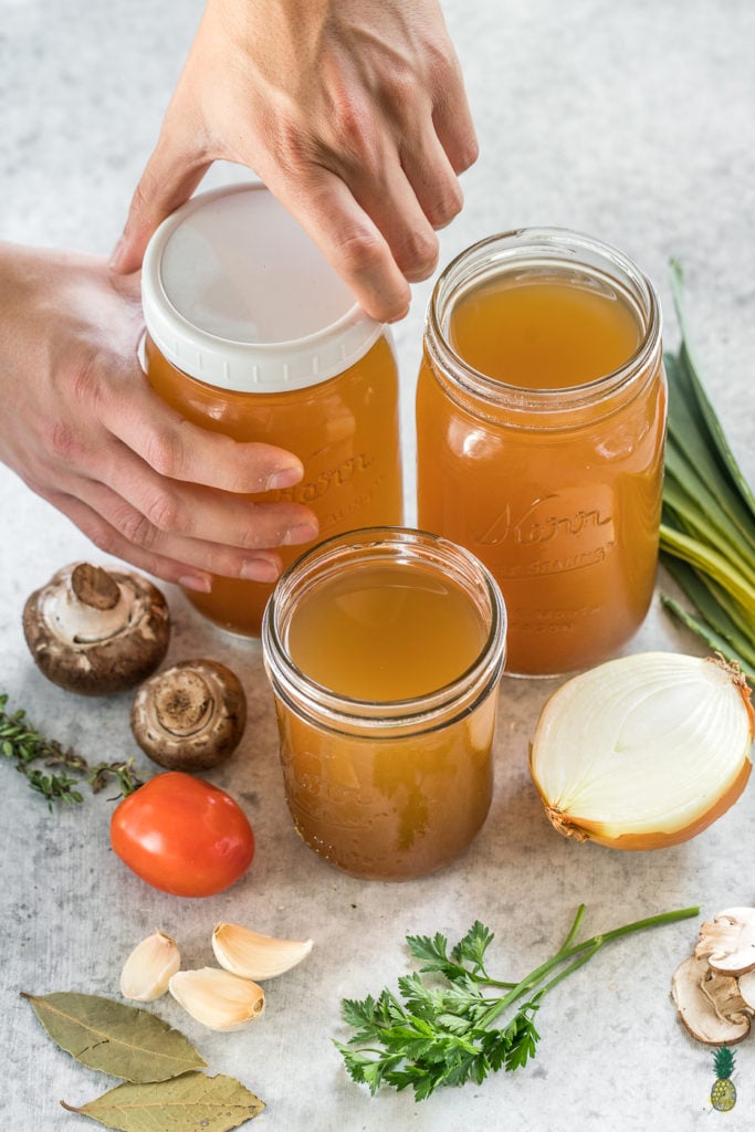 No need to buy vegetable broth from the store ever again! This step-by-step guide to making it at home is easy, cheap AND low-sodium! #homemade #vegetablebroth #vegetablestock #zerowaste #budget #lowsodium #healthy #vegan #oilfree #hack #diy
