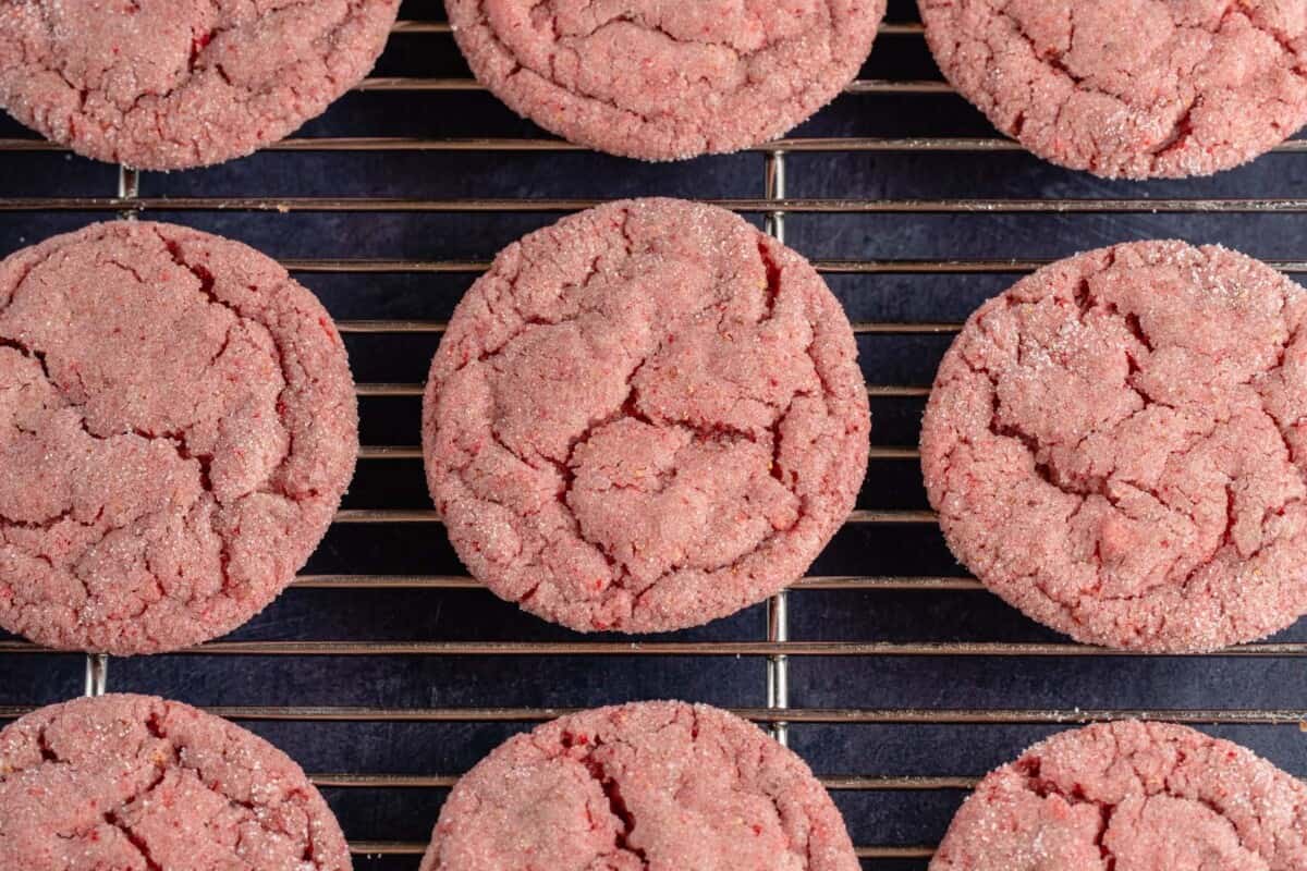 horizontal photo of strawberry sugar cookies on a silver cooling rack