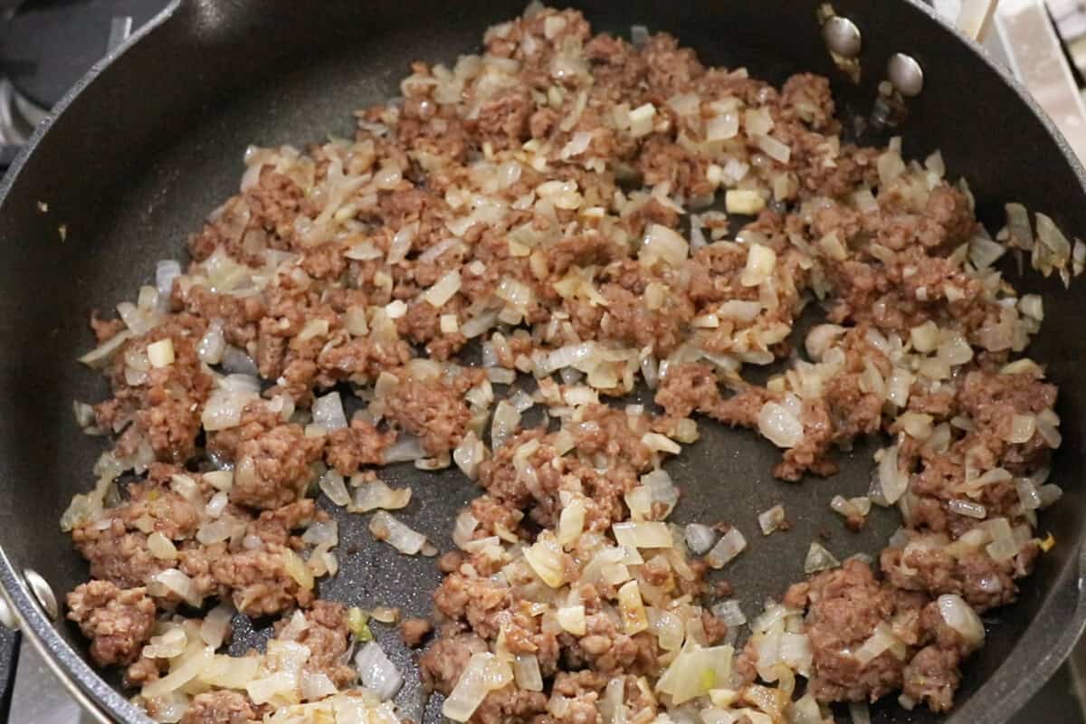vegan ground beef and onions in black pan