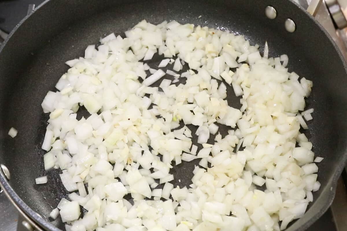 uncooked onions in black pan