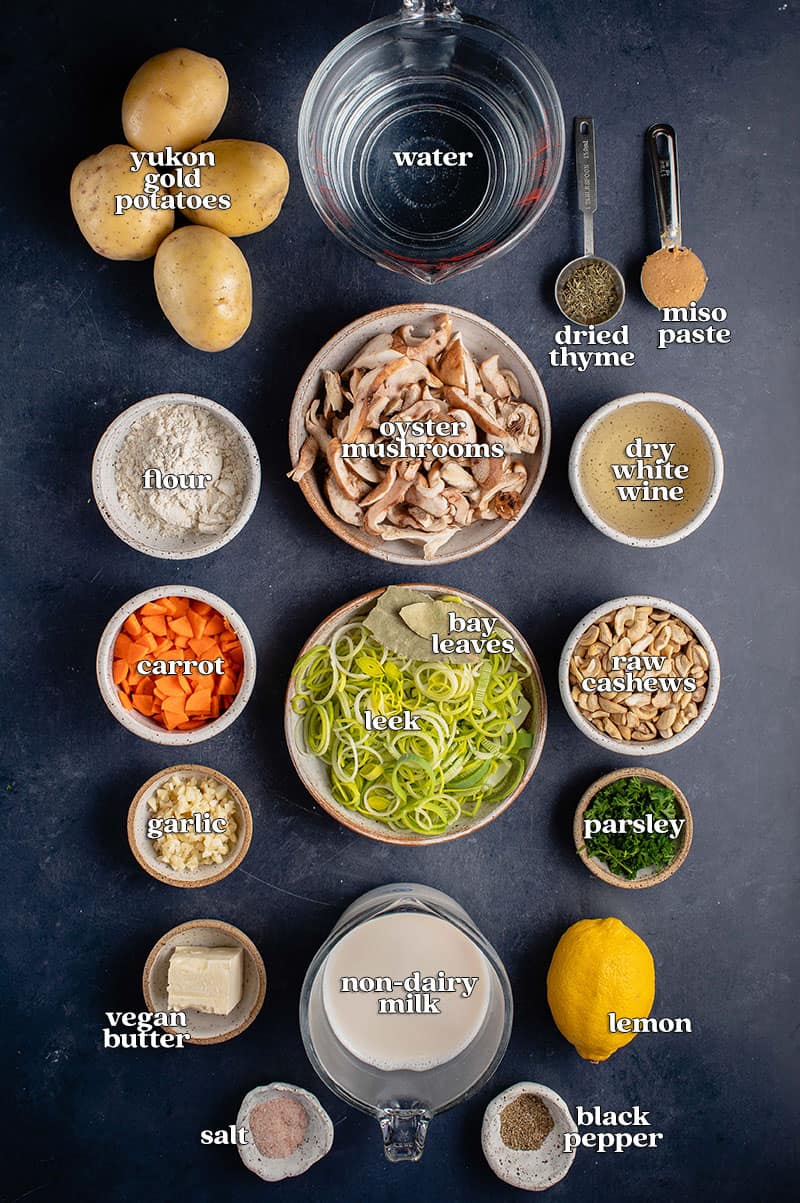 ingredients for vegan clam chowder labeled on blue table