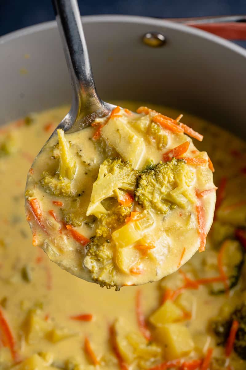 close up photo of creamy vegan broccoli potato soup in ladle