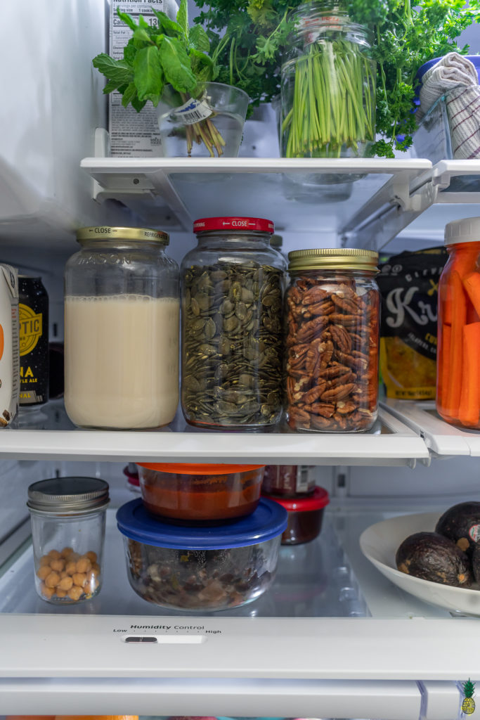 Nuts and seeds in jars in the refrigerator, sweet simple vegan fridge