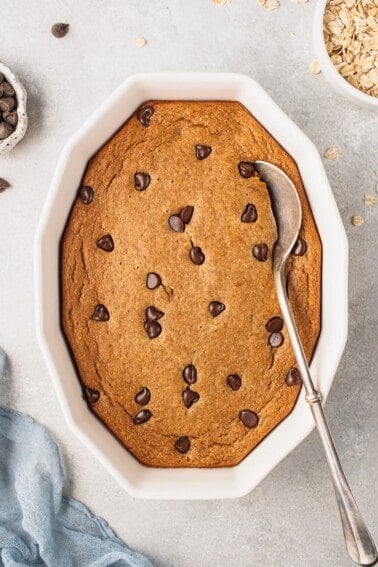 an overhead photo of chocolate chip baked oatmeal with a serving spoon