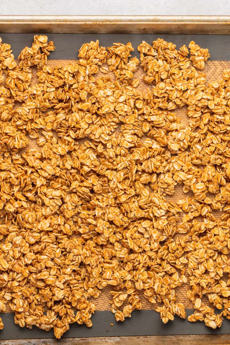 overhead image of peanut butter granola in baking sheet by sweetsimplevegan