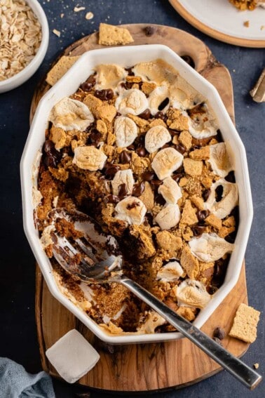 s'mores baked oatmeal in a dish with spoon