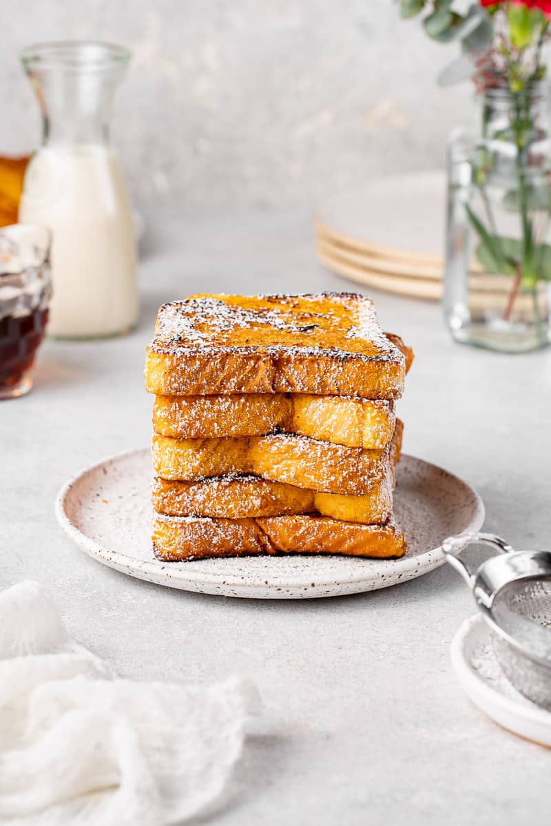 a stack of french toast dusted with powdered sugar