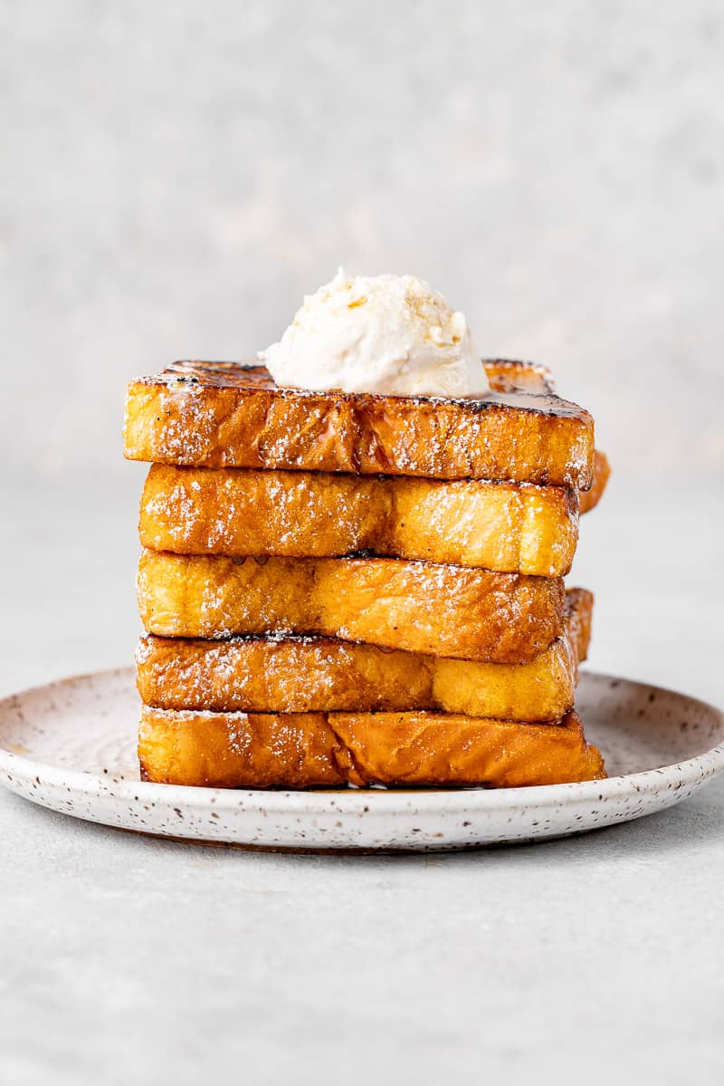 a stack of french toast with whipped cream