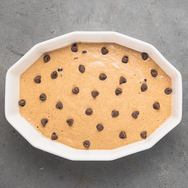 a photo of vegan baked oatmeal with chocolate chips on top before going into the oven