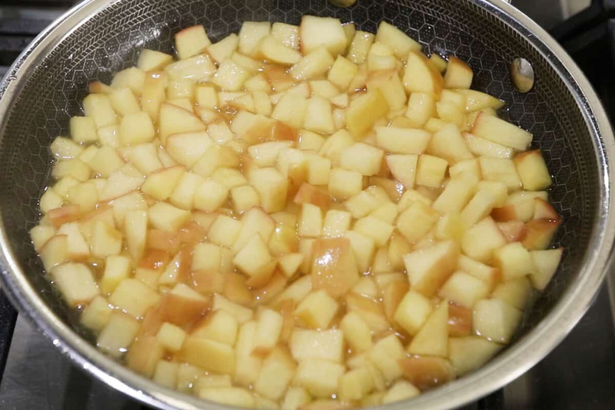 apples being cooked in a pan