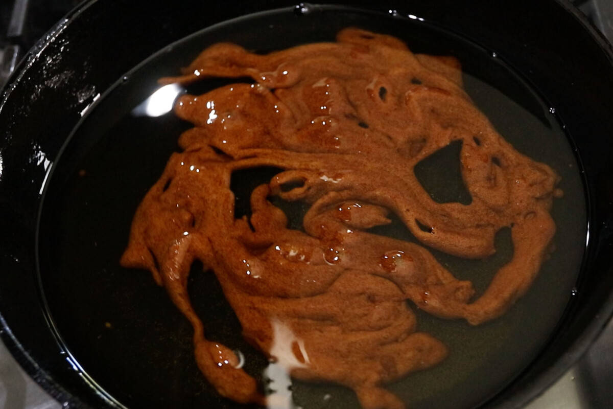 frying sweet potatoes and brown sugar for filipino kamote cue