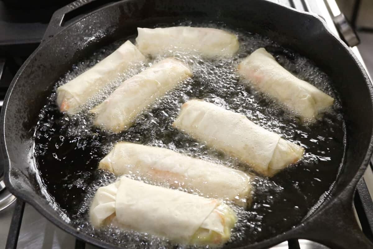 uncooked lumpiang gulay being fried