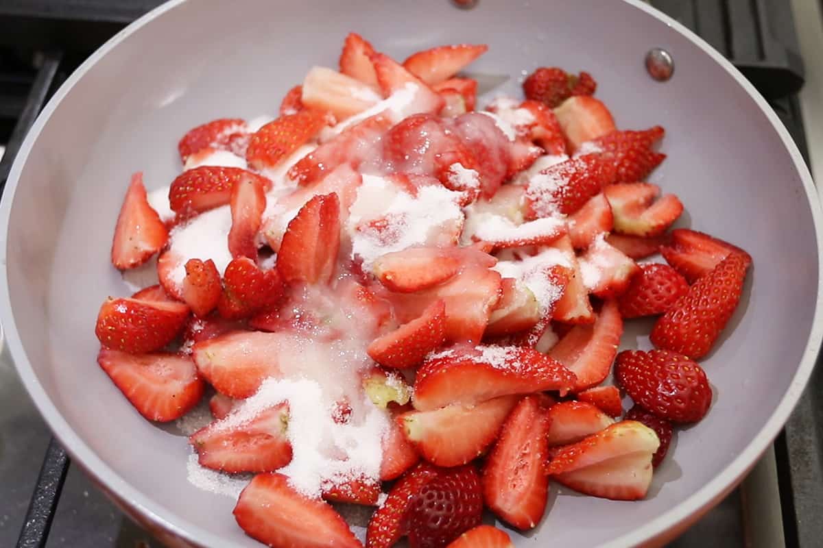 making a sweet strawberry topping for cheesecake in caraway non-stick pan