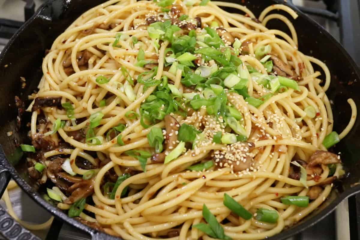 scallions and sesame seeds on pasta