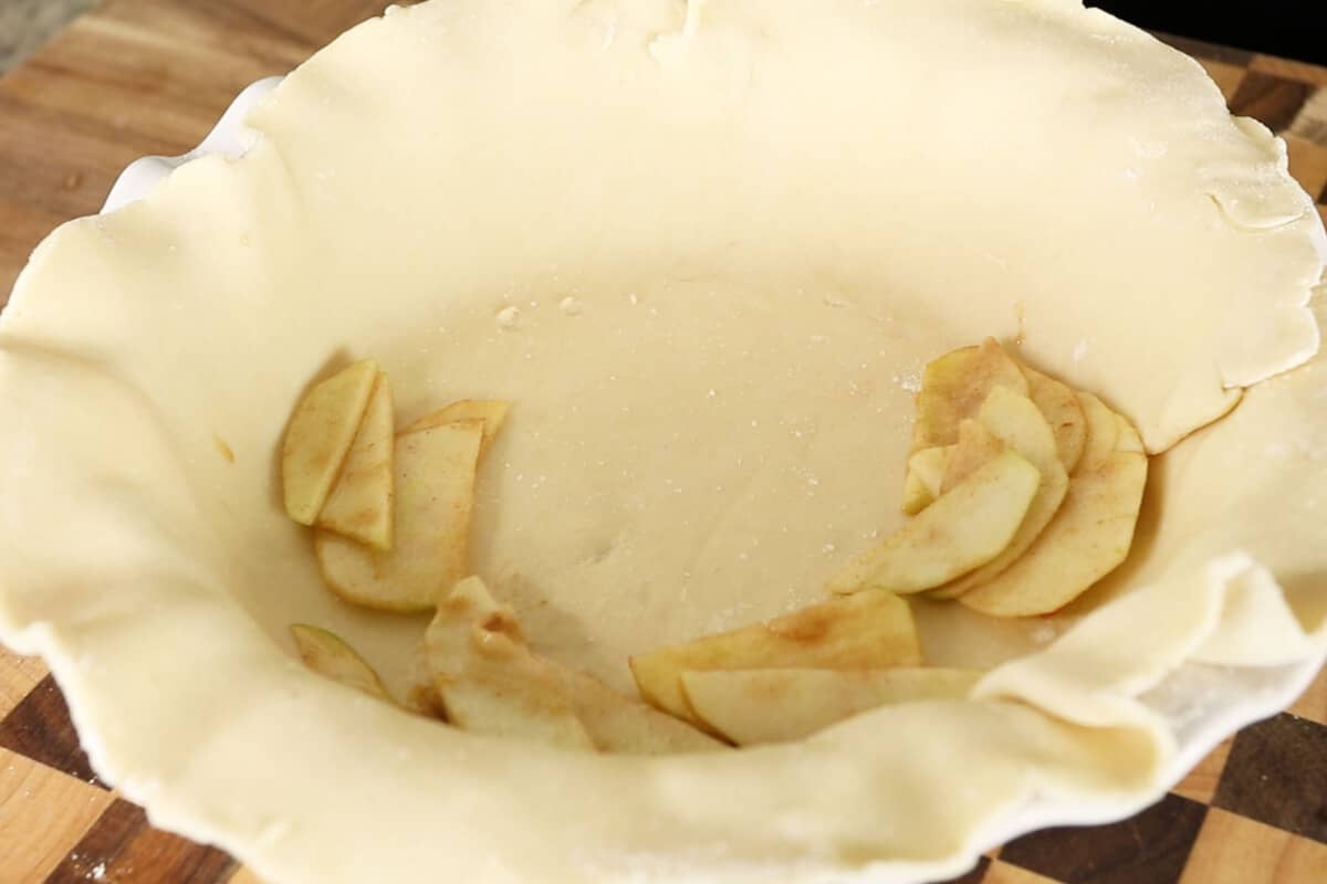 filling pie crust with apple pie filling