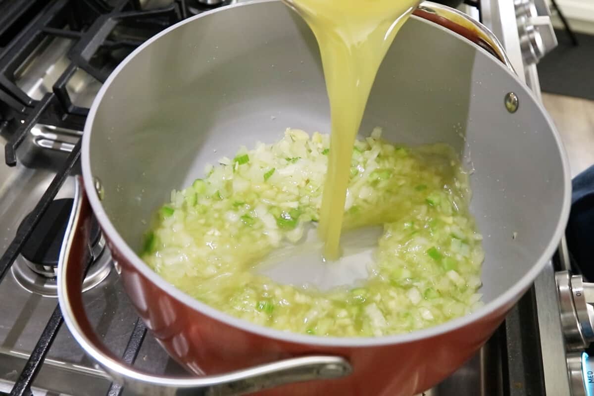 adding broth to large pot for broccoli potato soup