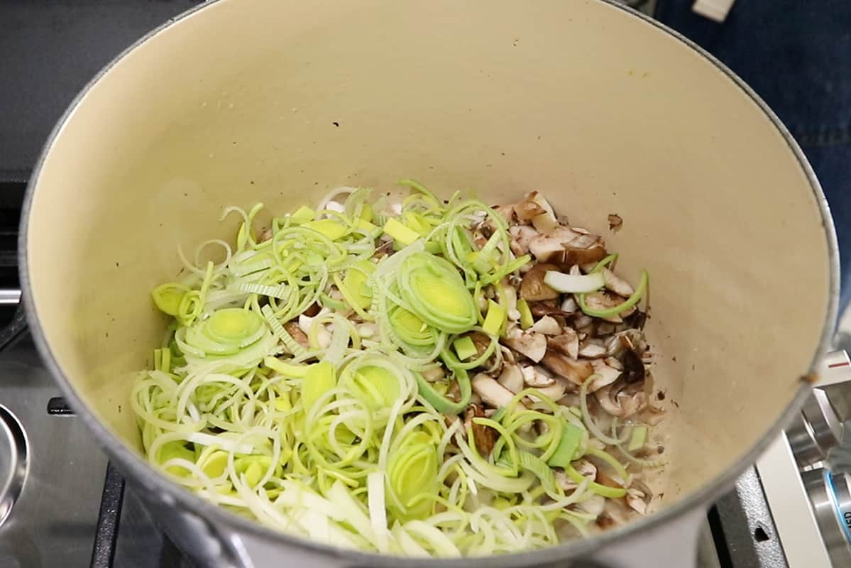 oyster mushrooms and leeks in pot with vegan butter