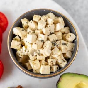 An easy and delicious vegan feta cheese that is made out of tofu and will make all of your dreams come true. This cheese swaps perfectly with its nonvegan counterpart and the possibilities for serving it are endless! #vegan #vegancheese #feta #easy #foolproof #salad #appetizer #side #avocadotoast #veganpasta #veganized #musttry