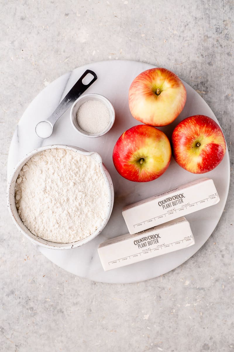 ingredients for vegan apple galette on a white marble board